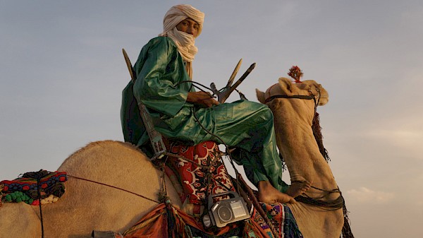 A participant at the Shiriken Festival, which celebrates Tuareg culture, dance and music, in Akoubounou, Niger; camels are integral to the traditional Tuareg way of life and the fest features camel races, desert blues music and even camel dancing, where riders make their camels step to a drumbeat: Photo by Christopher Kirkley